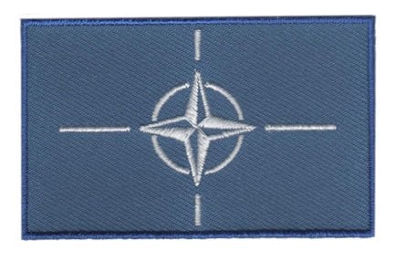 NATO flag patch with blue field and white compass rose emblem, 6.5 x 4 cm.