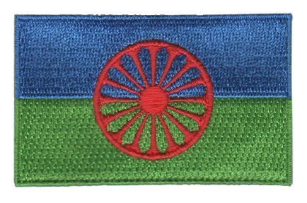 Romani flag patch with blue and green background, featuring a red 16-spoke wheel.