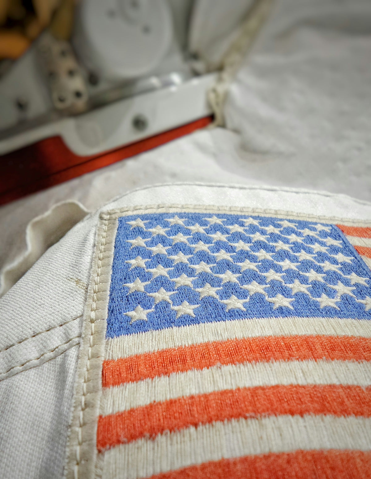 a close up of an american flag on a bed